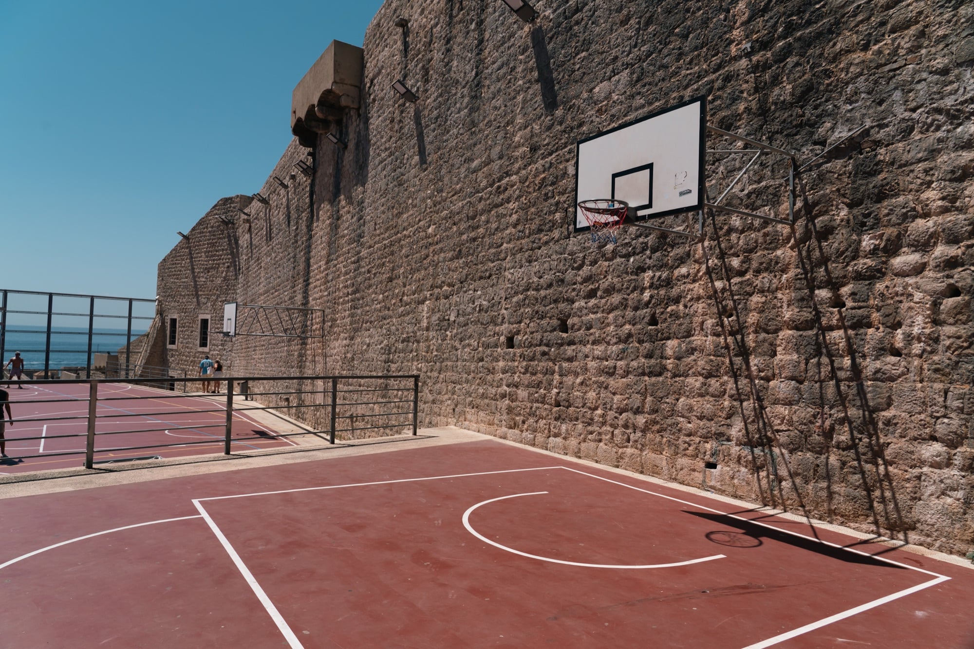 A basketball court tucked beneath the towering city walls, Dubrovnik